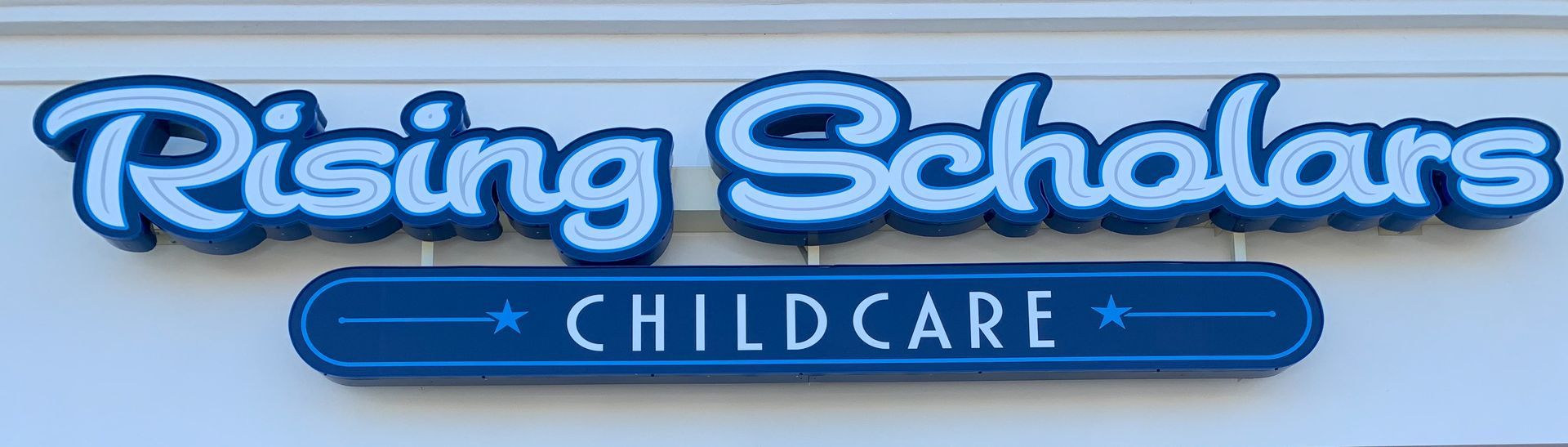 A channel letter sign that says Rising Scholars