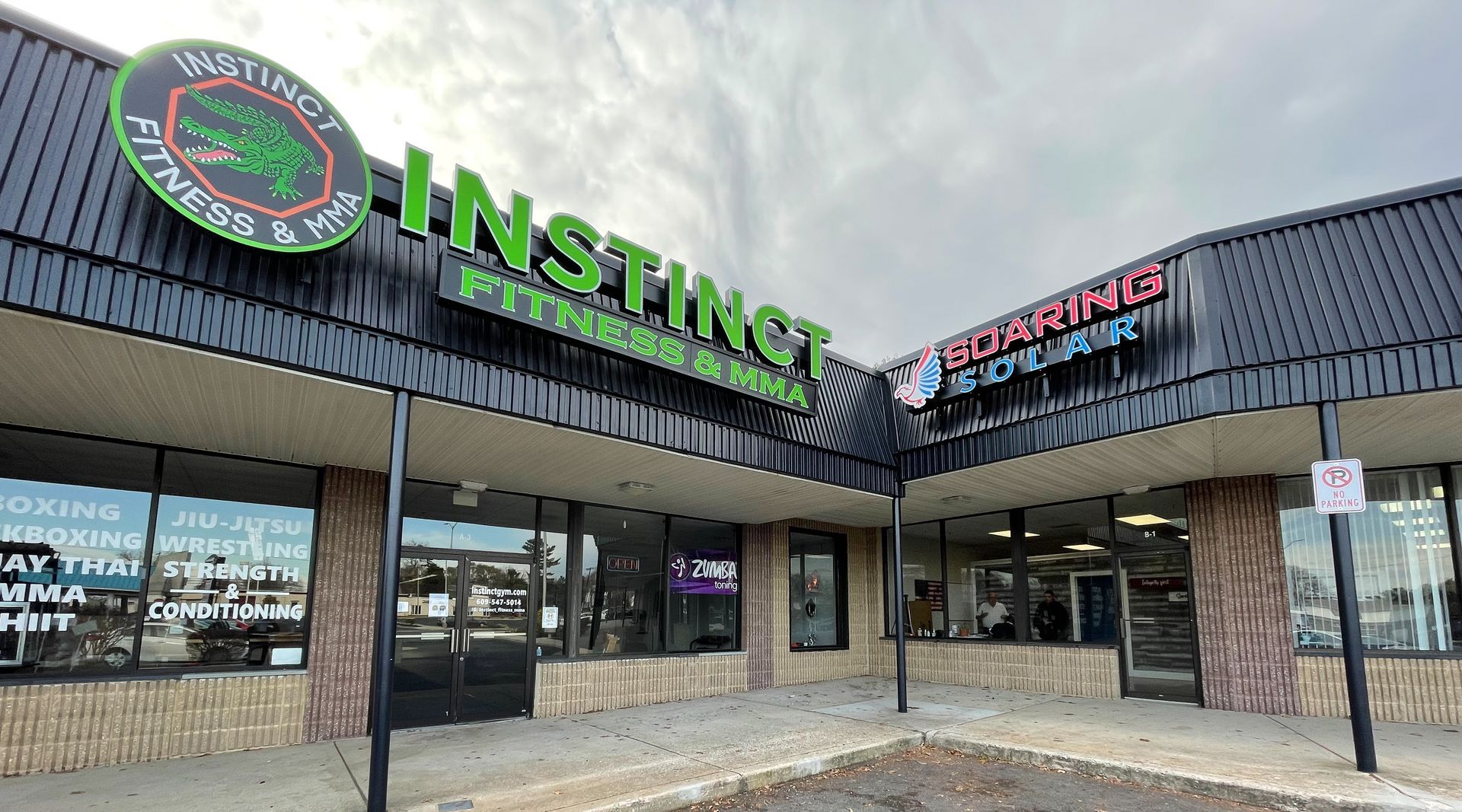 A channel letter sign that says Instinct Fitness & MMA