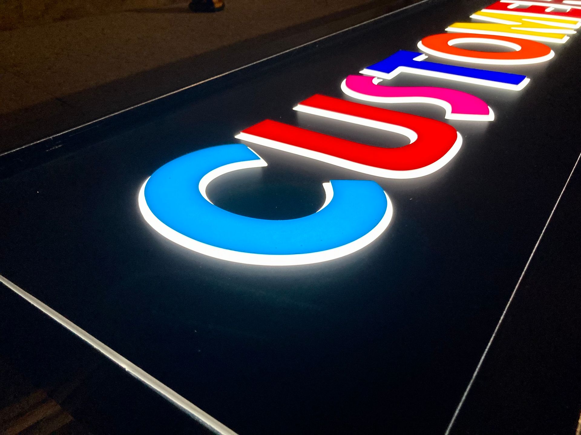 A colorful sign that says custom on it.