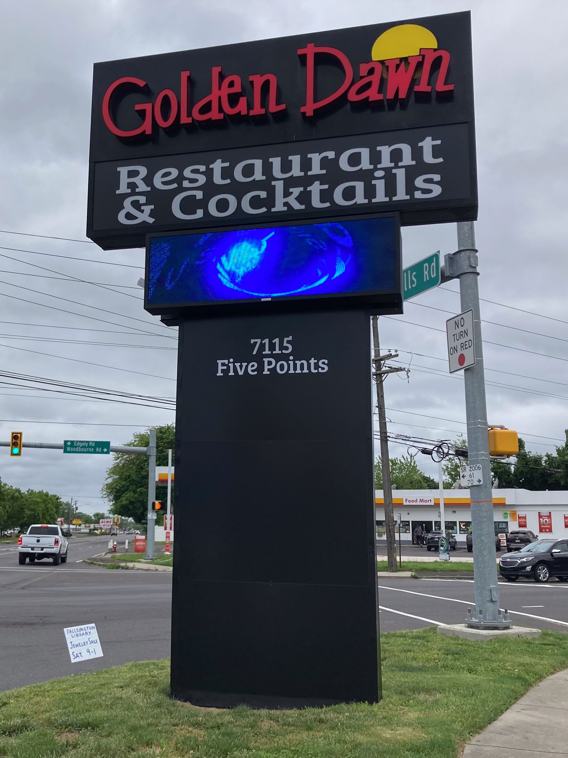A free-standing sign that says Golden Dawn Restaurant & Cocktails