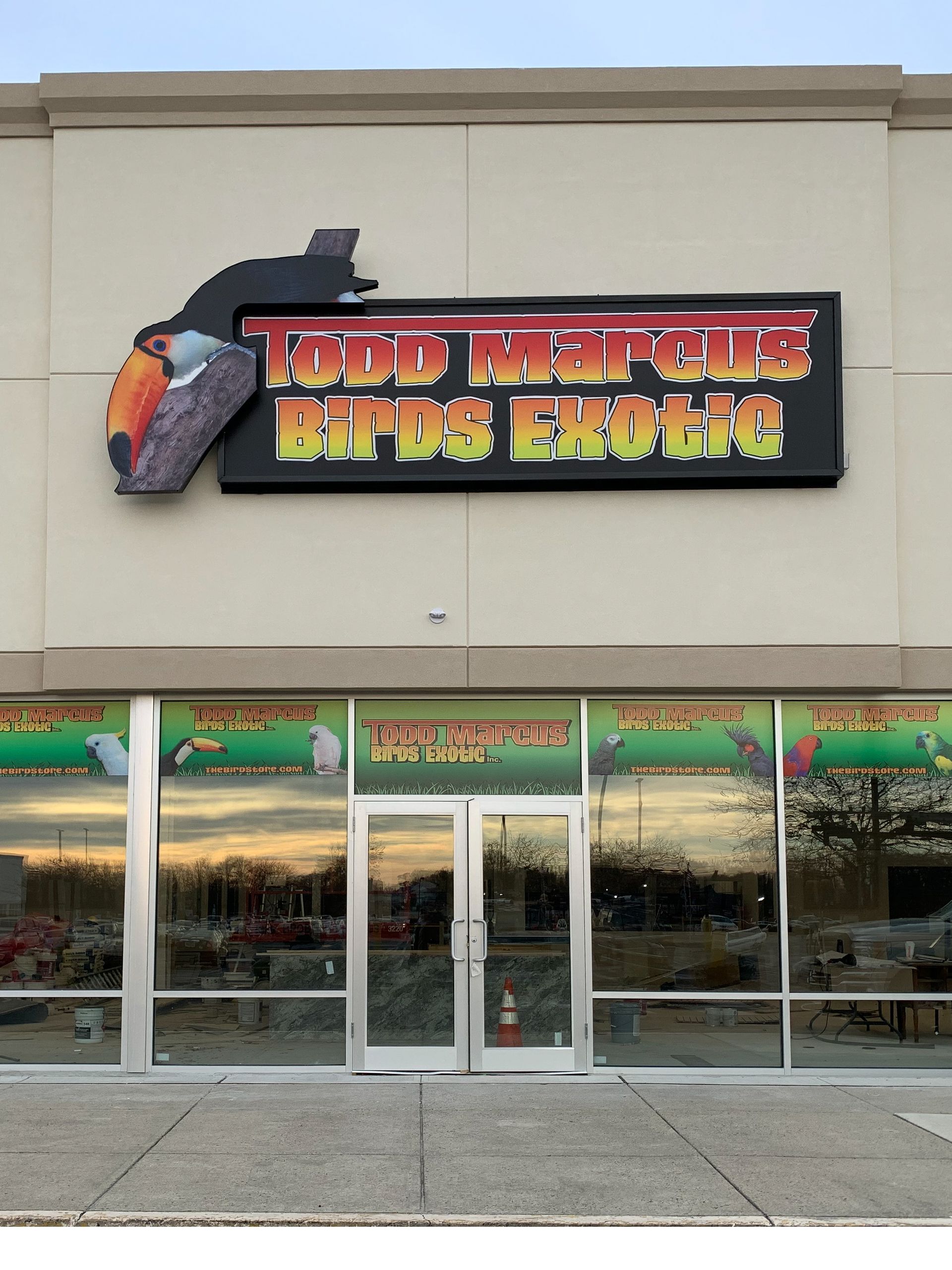 A storefront with a box sign that says Todd Marcus Birds Exotic