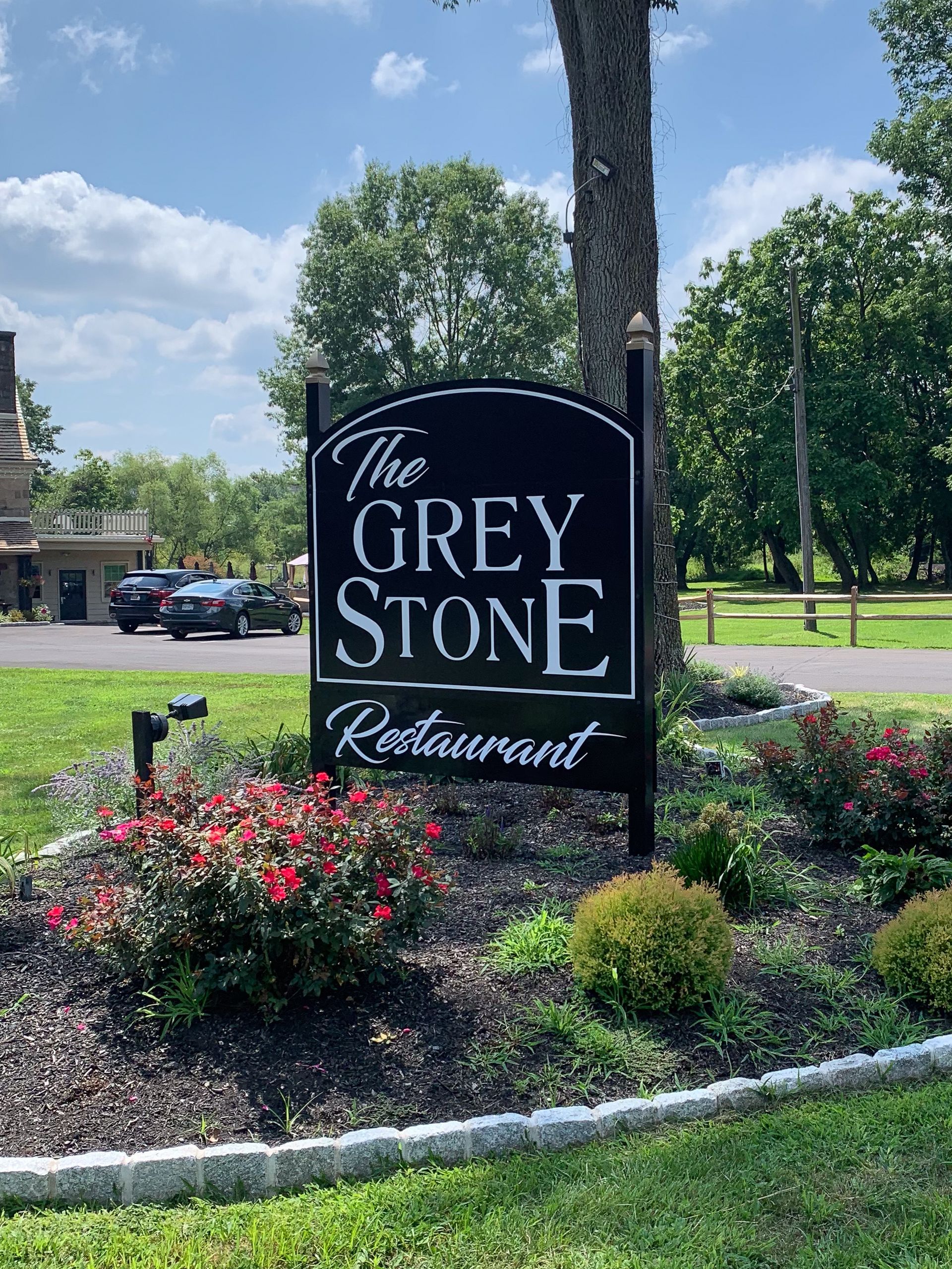 A free-standing that says The Grey Stone Restaurant.