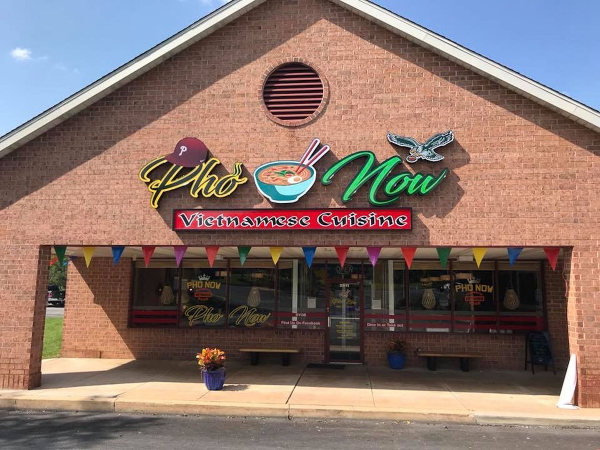 A Vietnamese restaurant with a sign that reads Pho Now.
