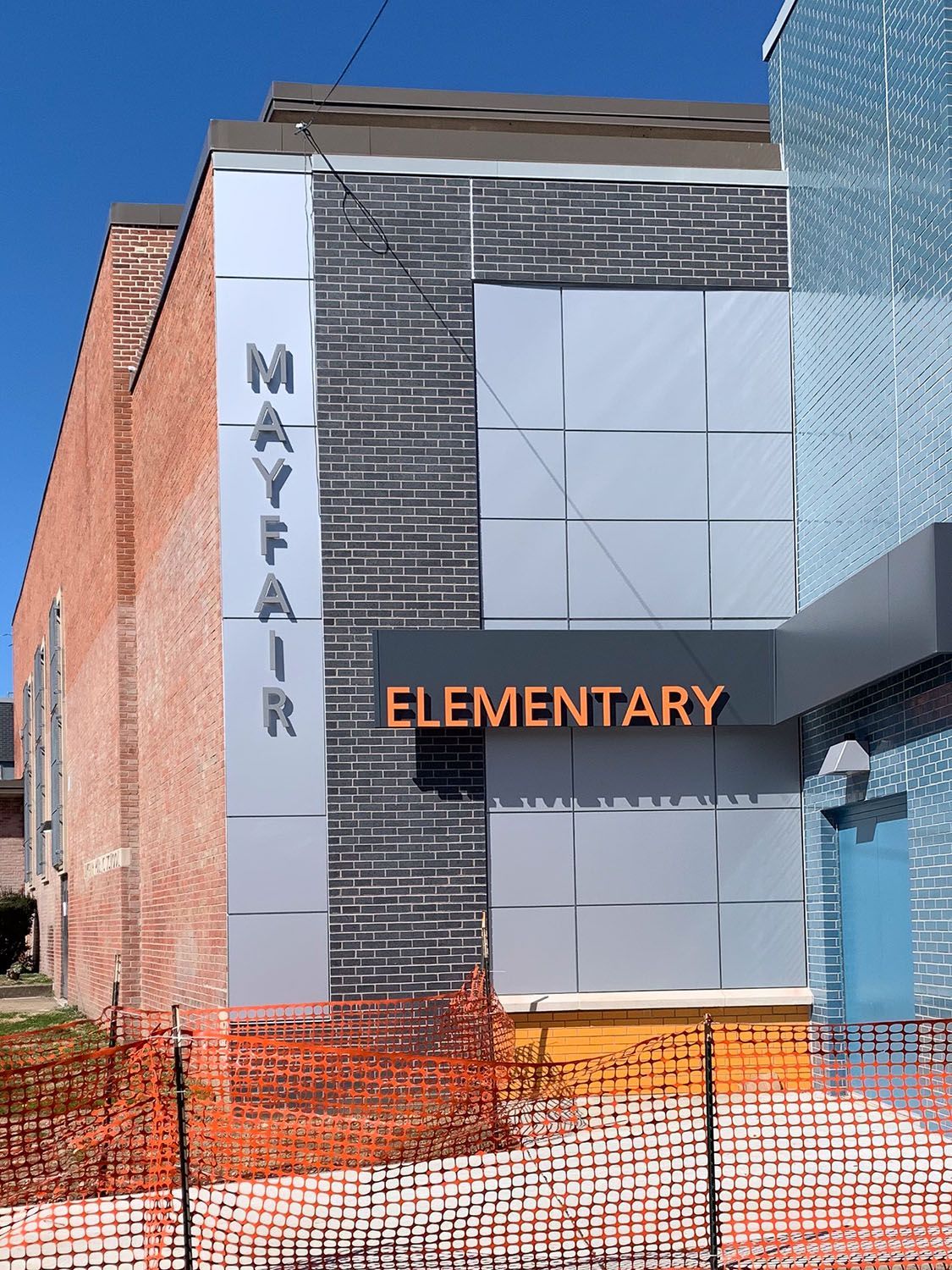 A brick building with a sign that says mayfair elementary