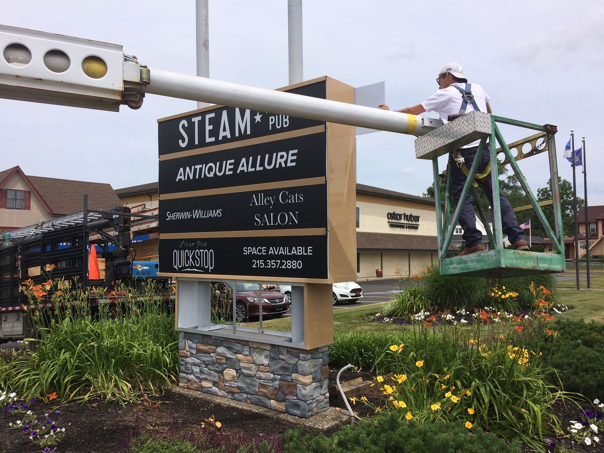 A free-standing sign is being installed.