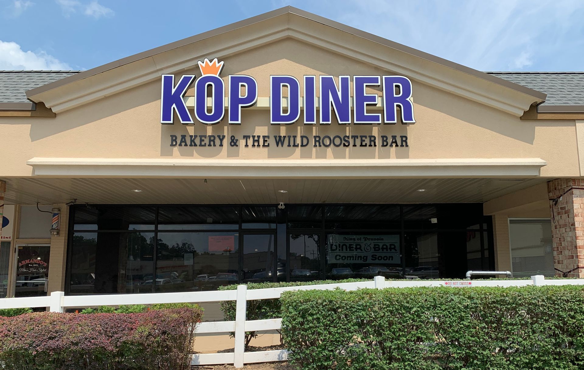 The front of a restaurant called kop diner bakery and the wild rooster bar