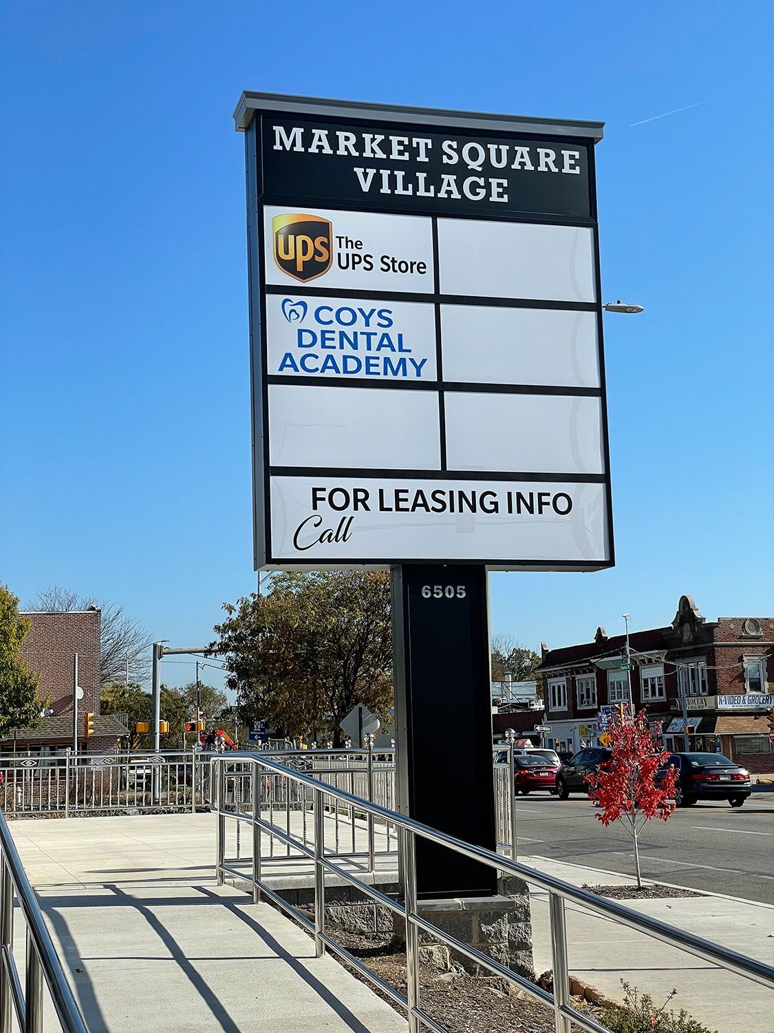 A free-standing sign installed next to a sidewalk.