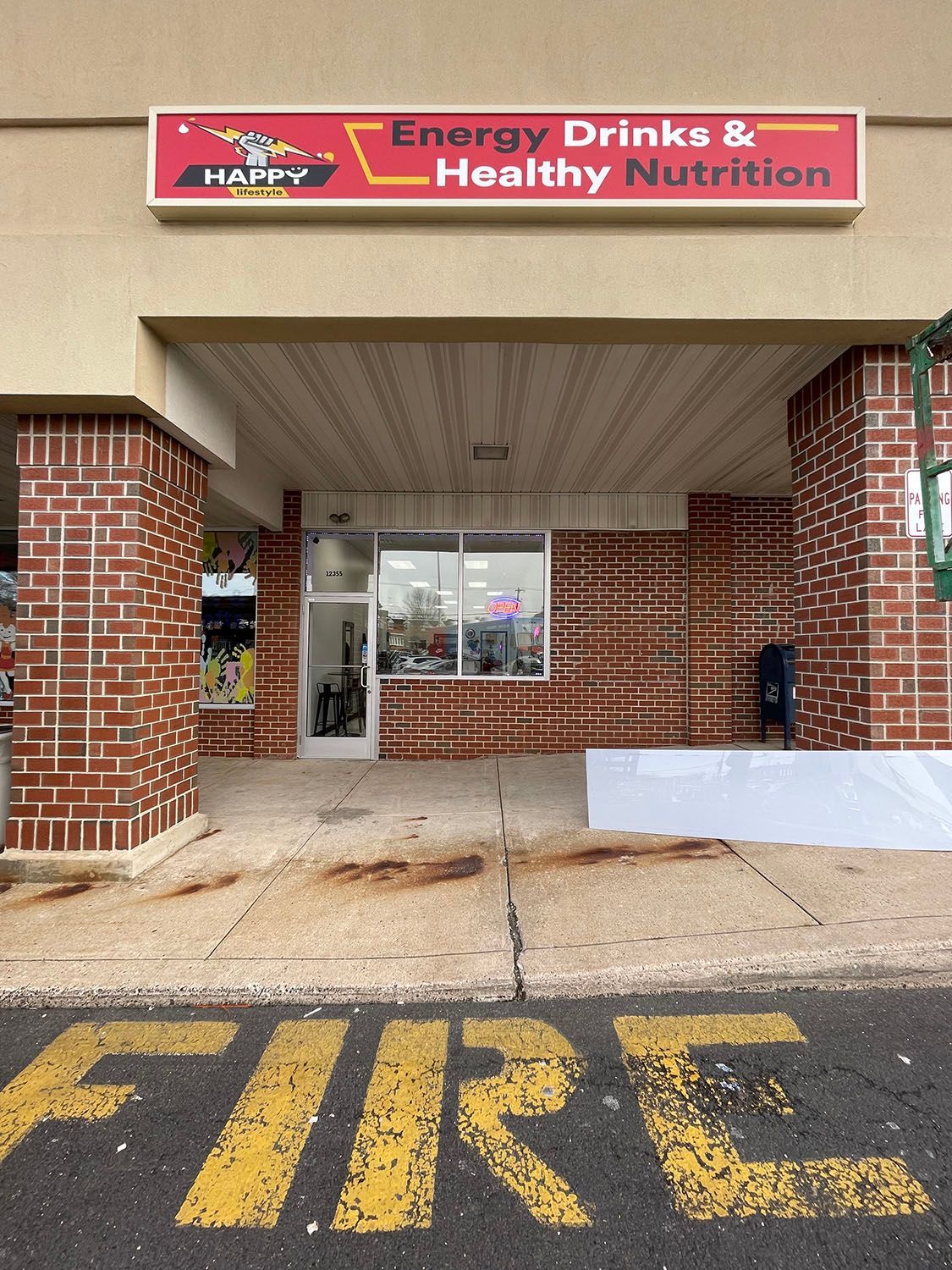 A box sign for Happy Lifestyle that reads Energy Drinks and Healthy Nutrition.