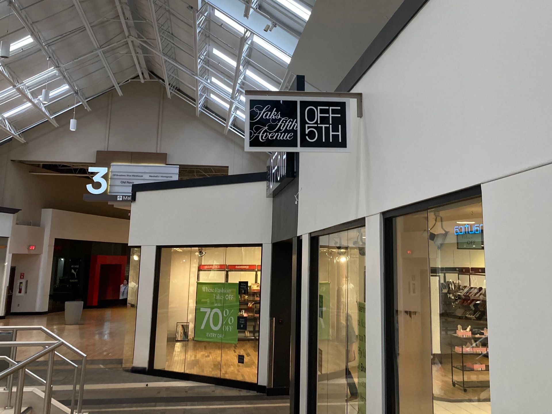 A store in a mall with a sign that says Off 5th