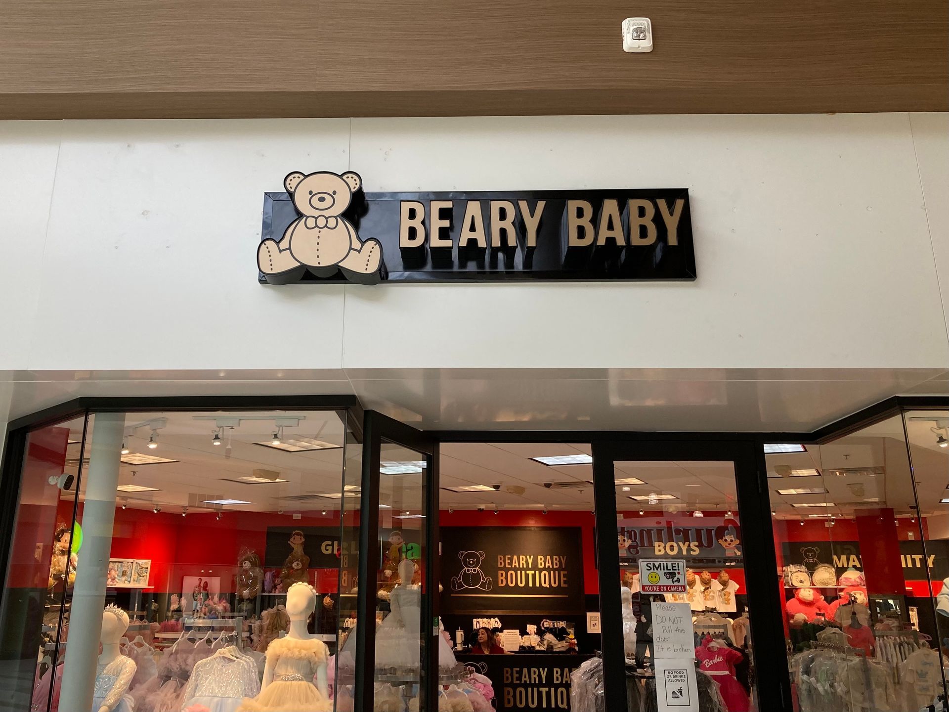 The front of a store called Beary Baby with a teddy bear on the sign.