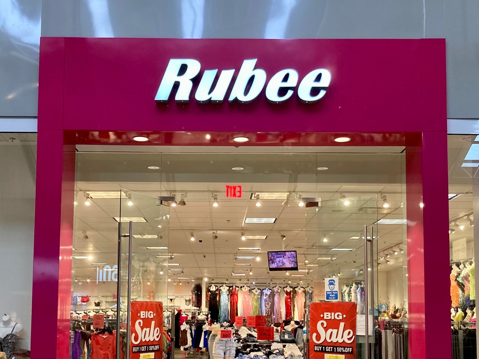 A store front with a pink sign that says Rubee