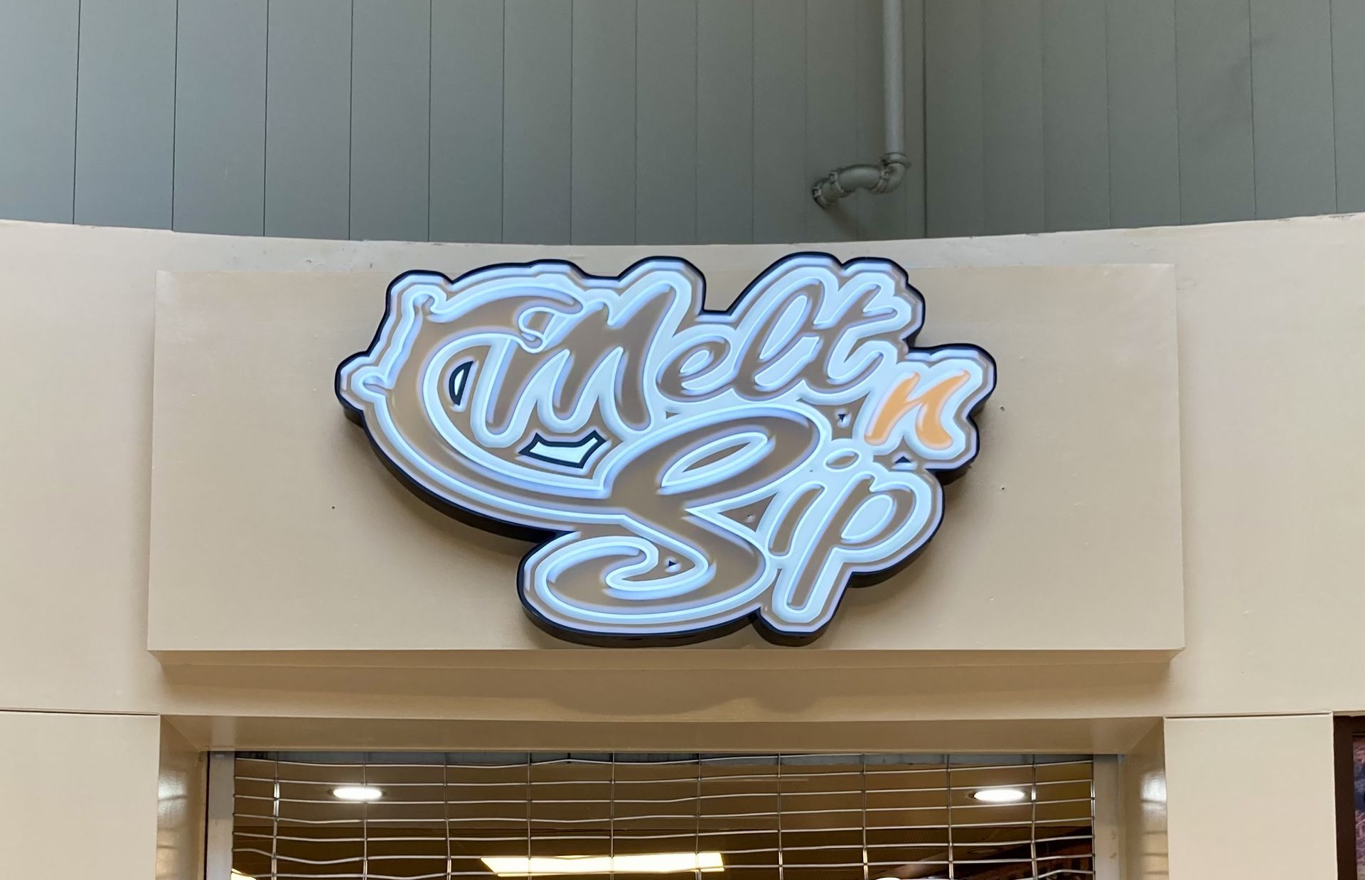 A store front with a neon sign that says `` mellow zip ''.