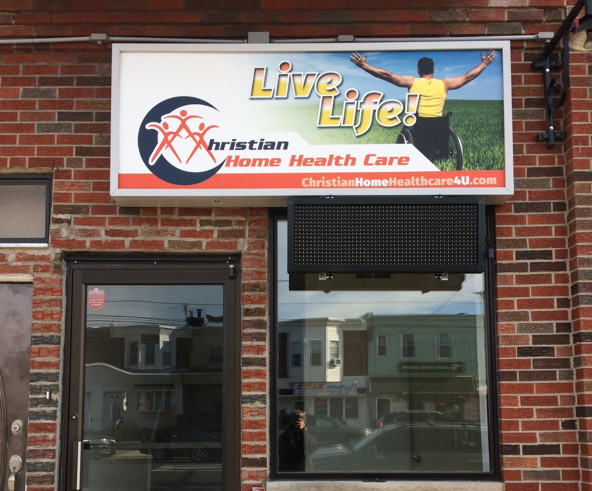 A brick building with a sign that says live life