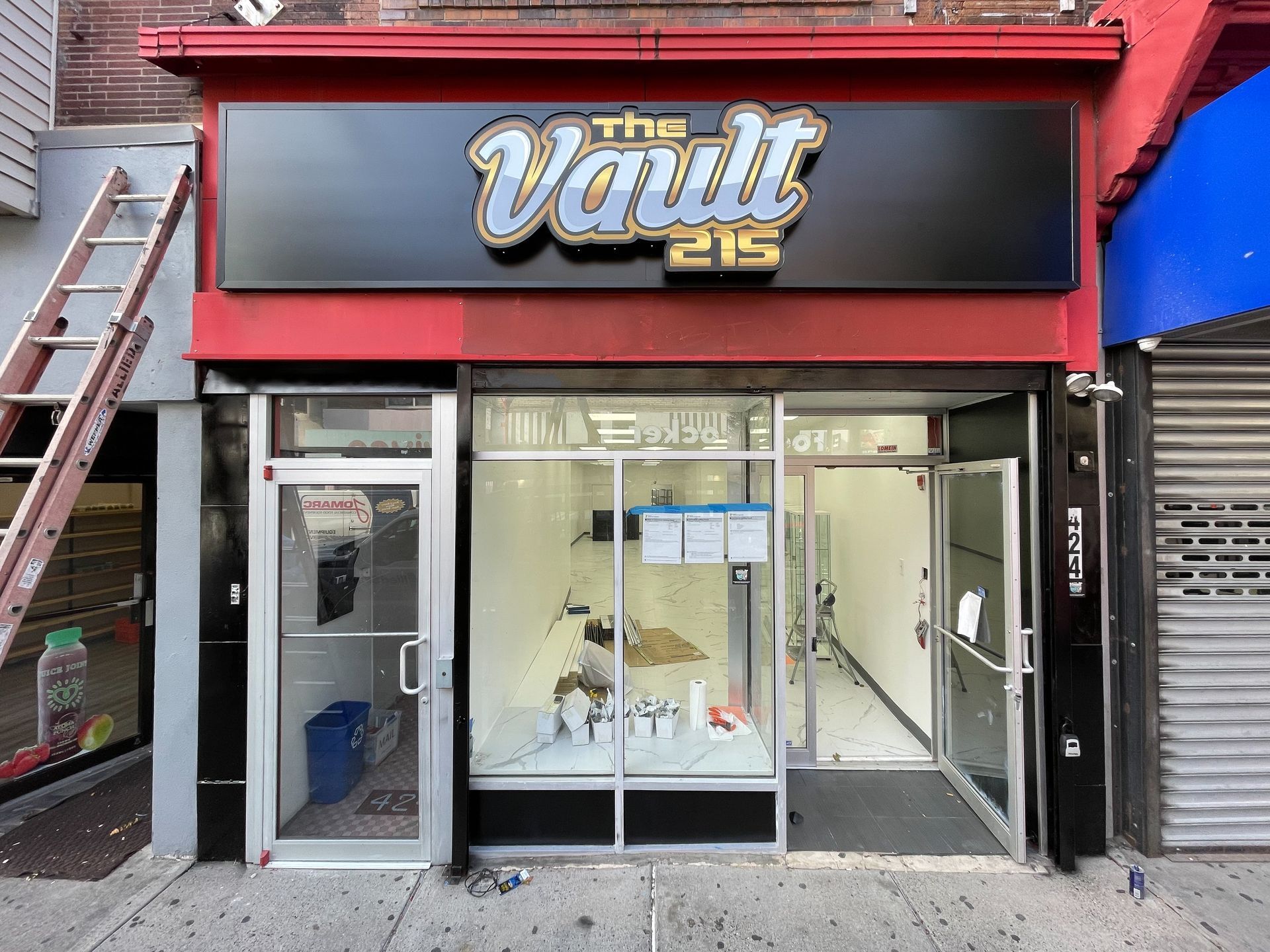 A store front with a sign that says the vault 215