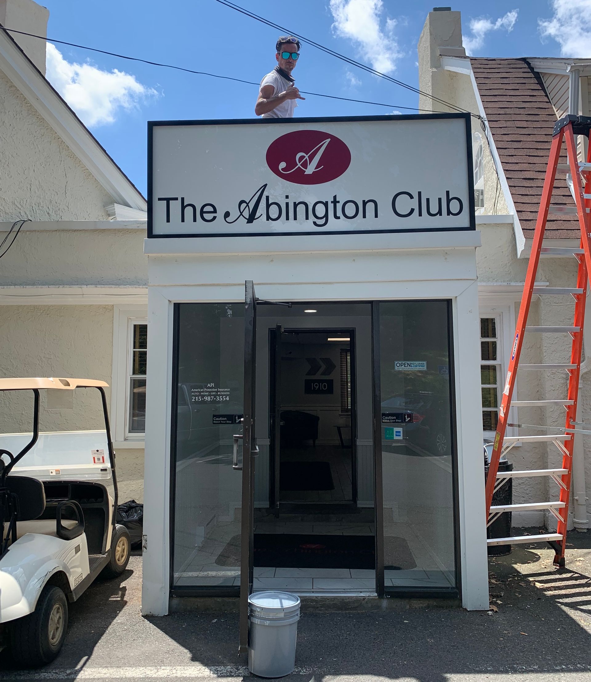 A man is standing on the roof of the washington club