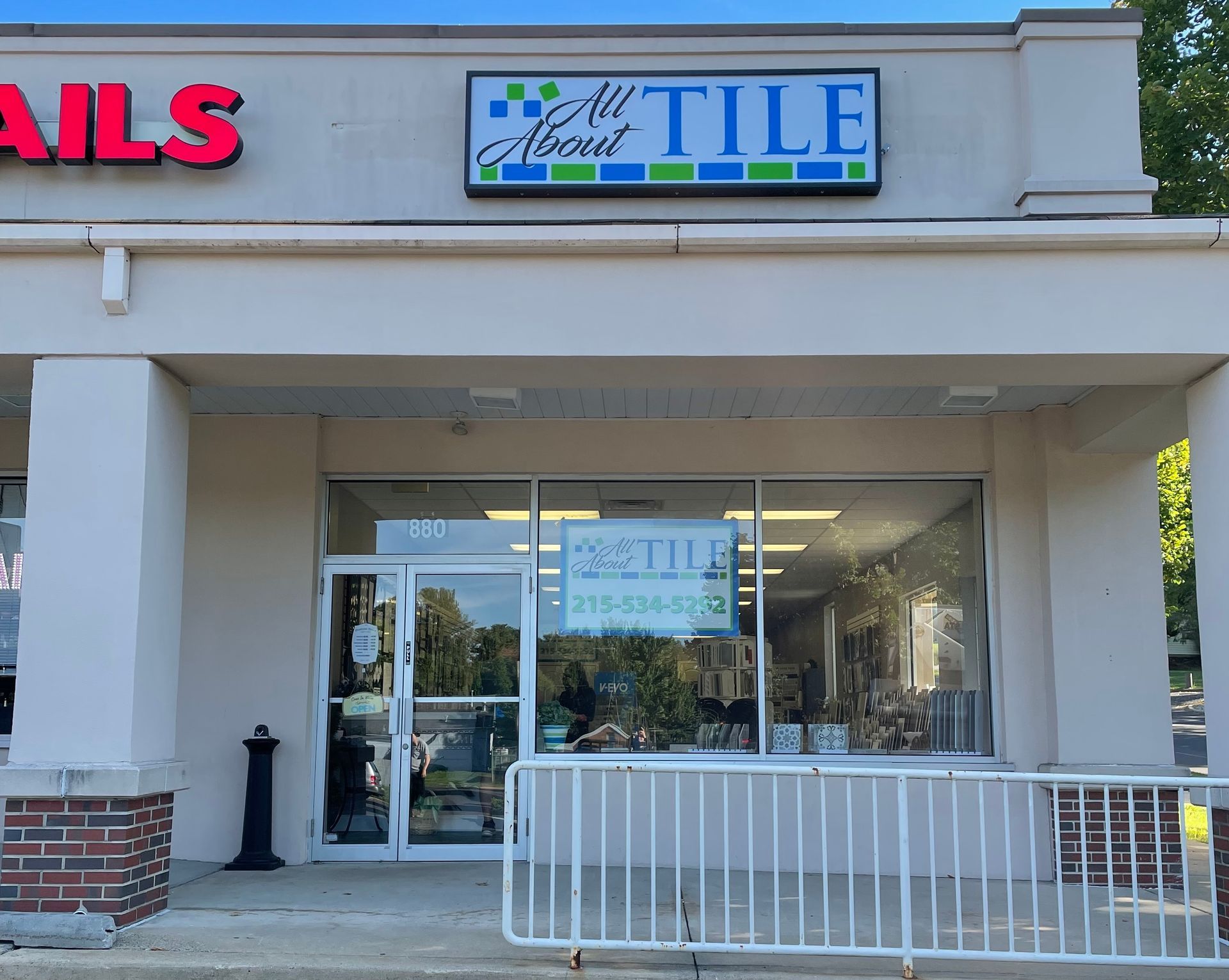 A store front with a sign that says tile on it