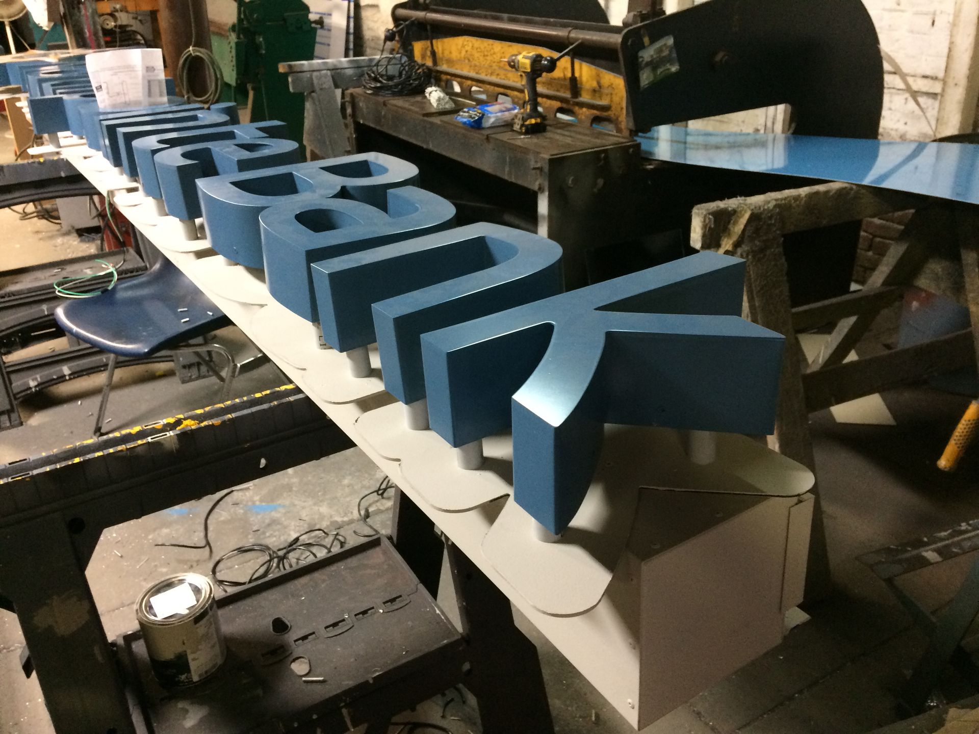 A blue and white sign that says bank is sitting on a table.