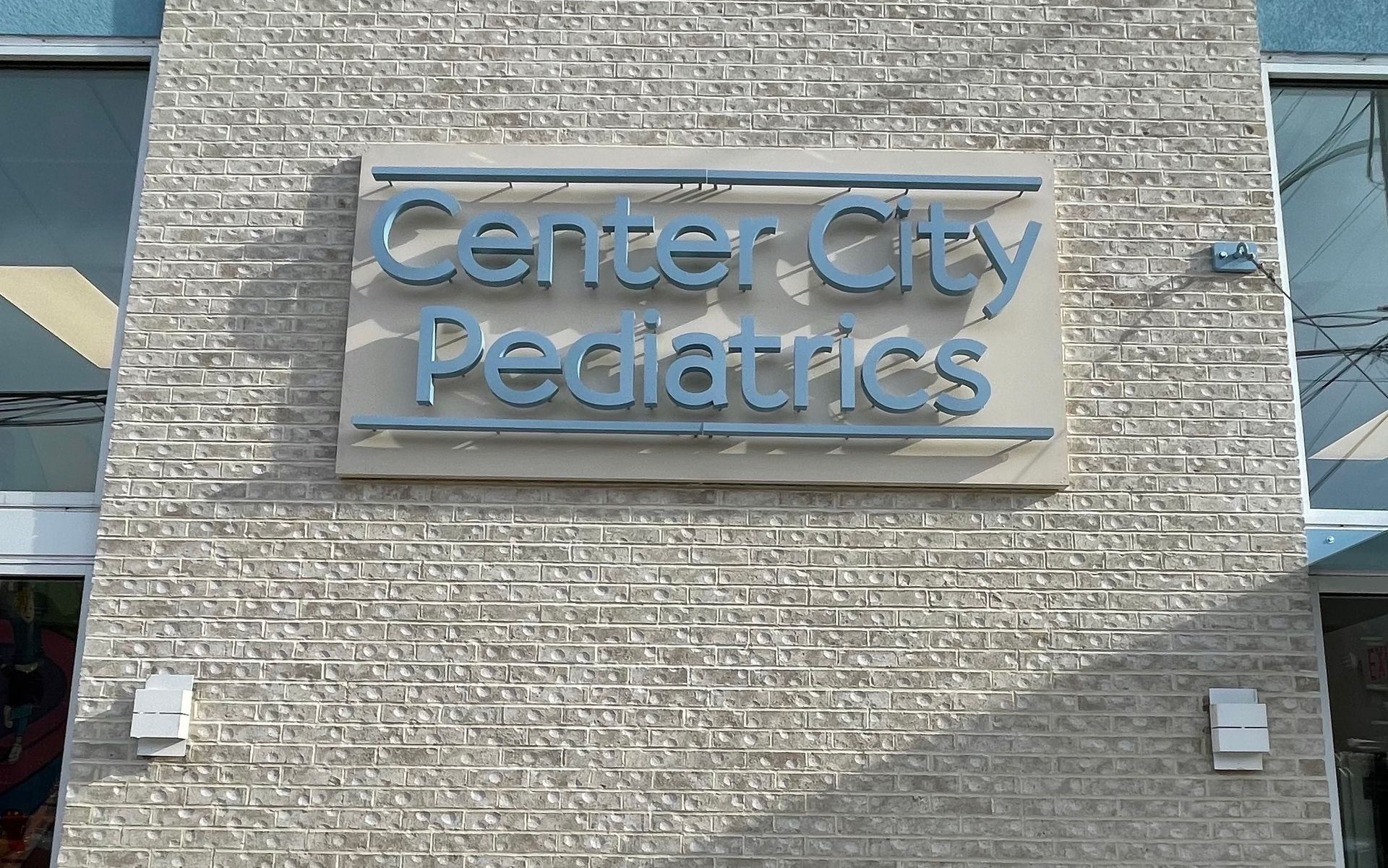 A brick building with a sign that says center city pediatrics