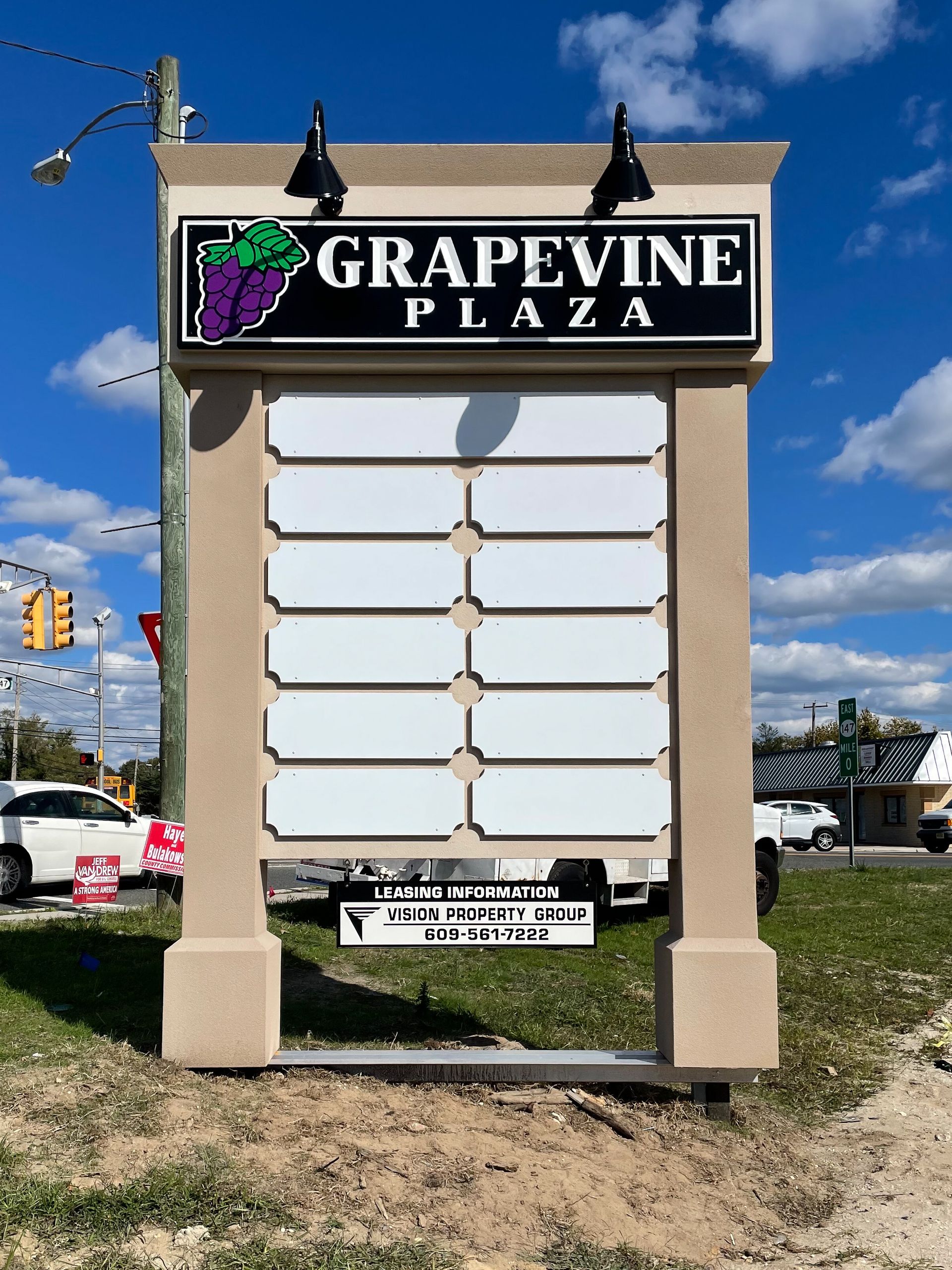 A large sign that says grapevine plaza on it