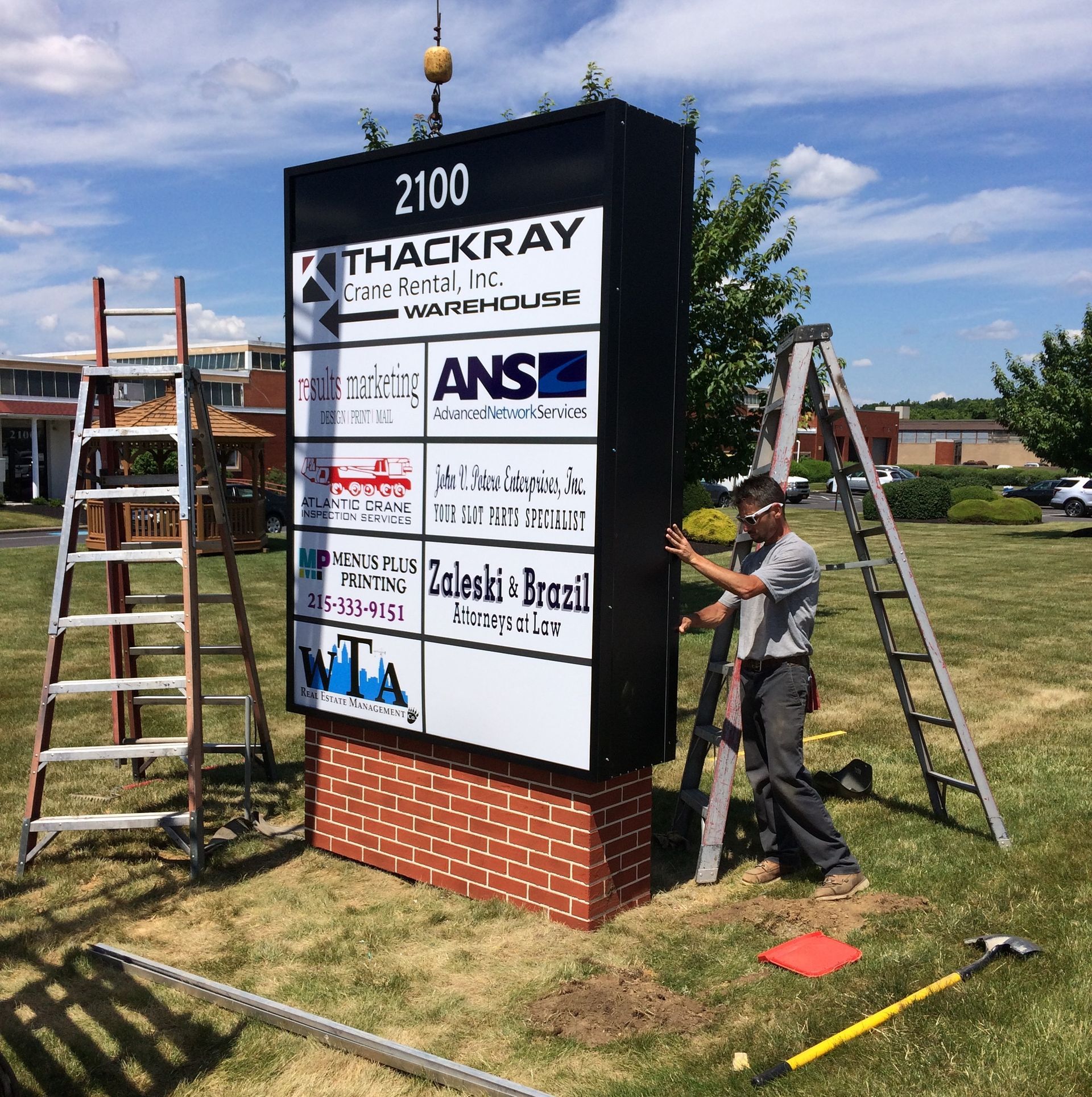 A man standing next to a sign that says 2100