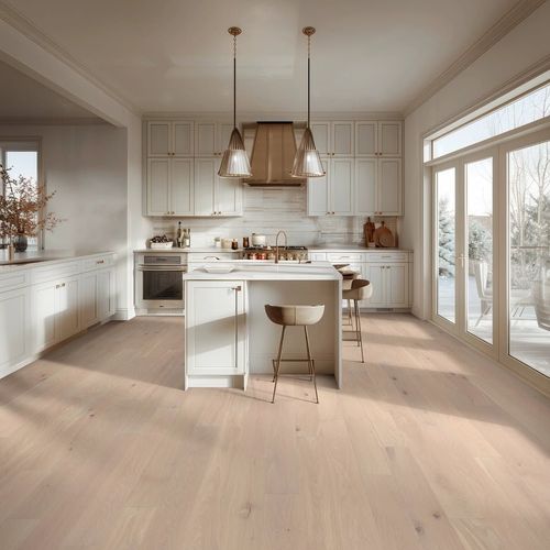 Bright modern kitchen with white cabinets, island, pendant lights, and large windows overlooking trees