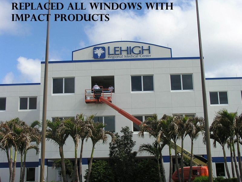 A construction crew in a lift replaces windows on the front of a building labeled Lehigh Regional Medical Center.