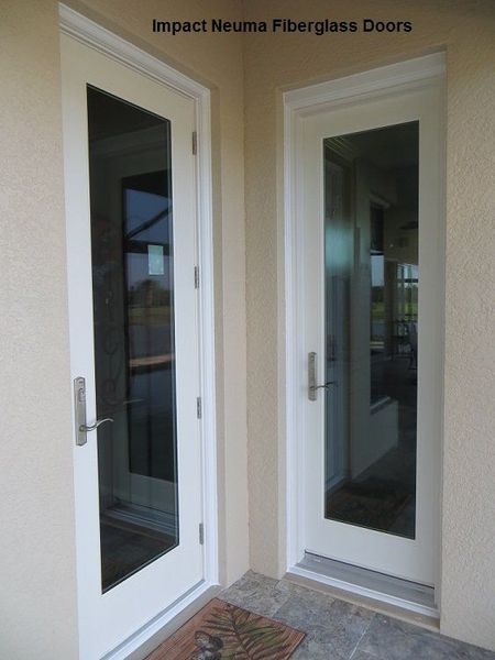 Two white Neuma fiberglass doors with full-length glass panes installed in a light-colored stucco exterior wall.