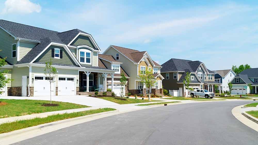 a row of houses are lined up on a residential street