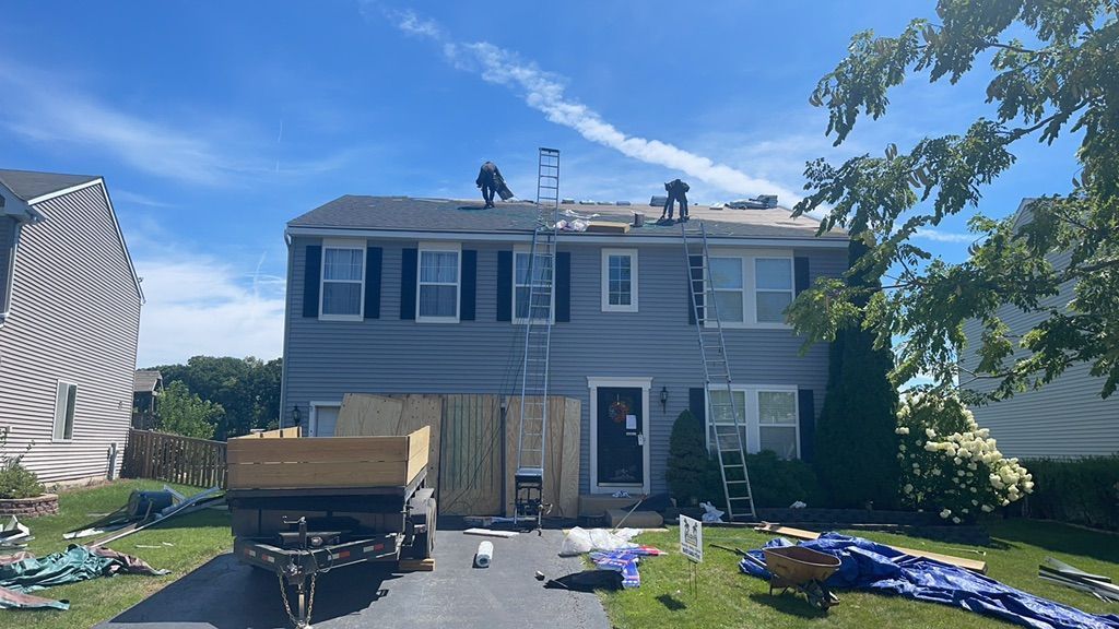 A house is being remodeled with a truck parked in front of it.