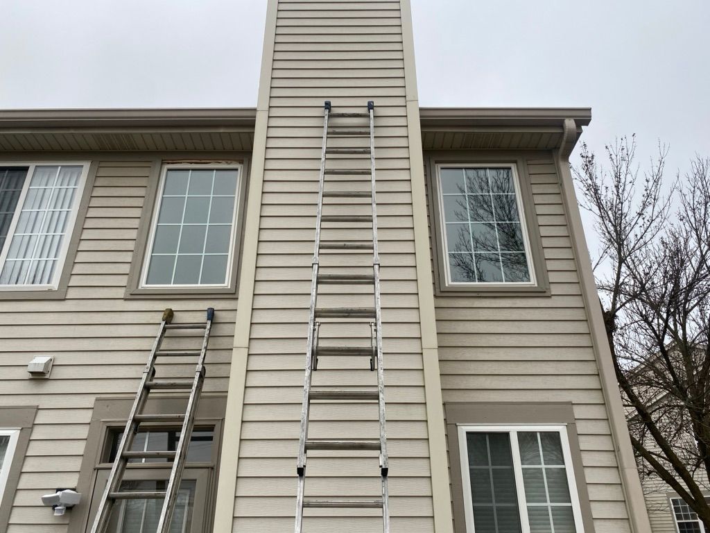 A ladder is attached to the side of a house.