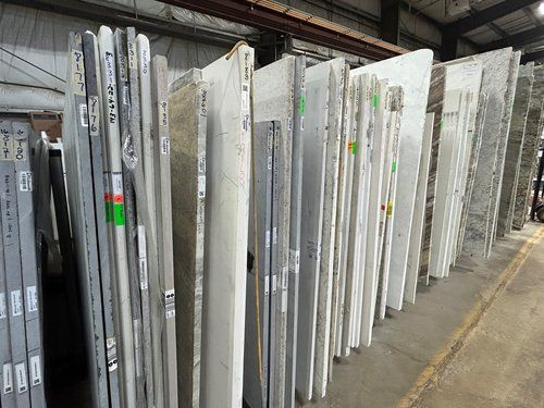 A warehouse filled with lots of white marble slabs.