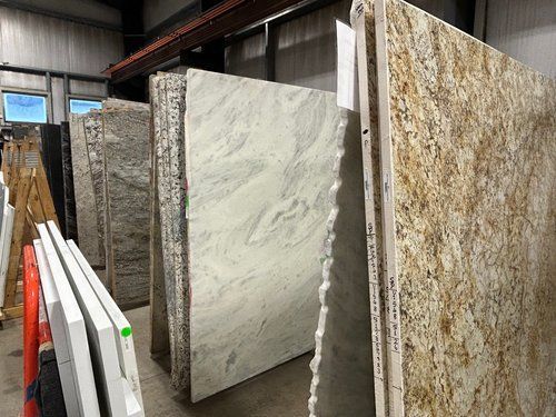 A warehouse filled with lots of different types of granite slabs.