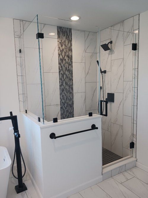 A bathroom with a walk in shower and a bathtub.