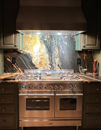 A stainless steel stove top oven is sitting in a kitchen.
