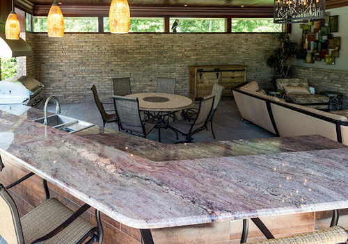 A kitchen with a marble counter top and a table and chairs
