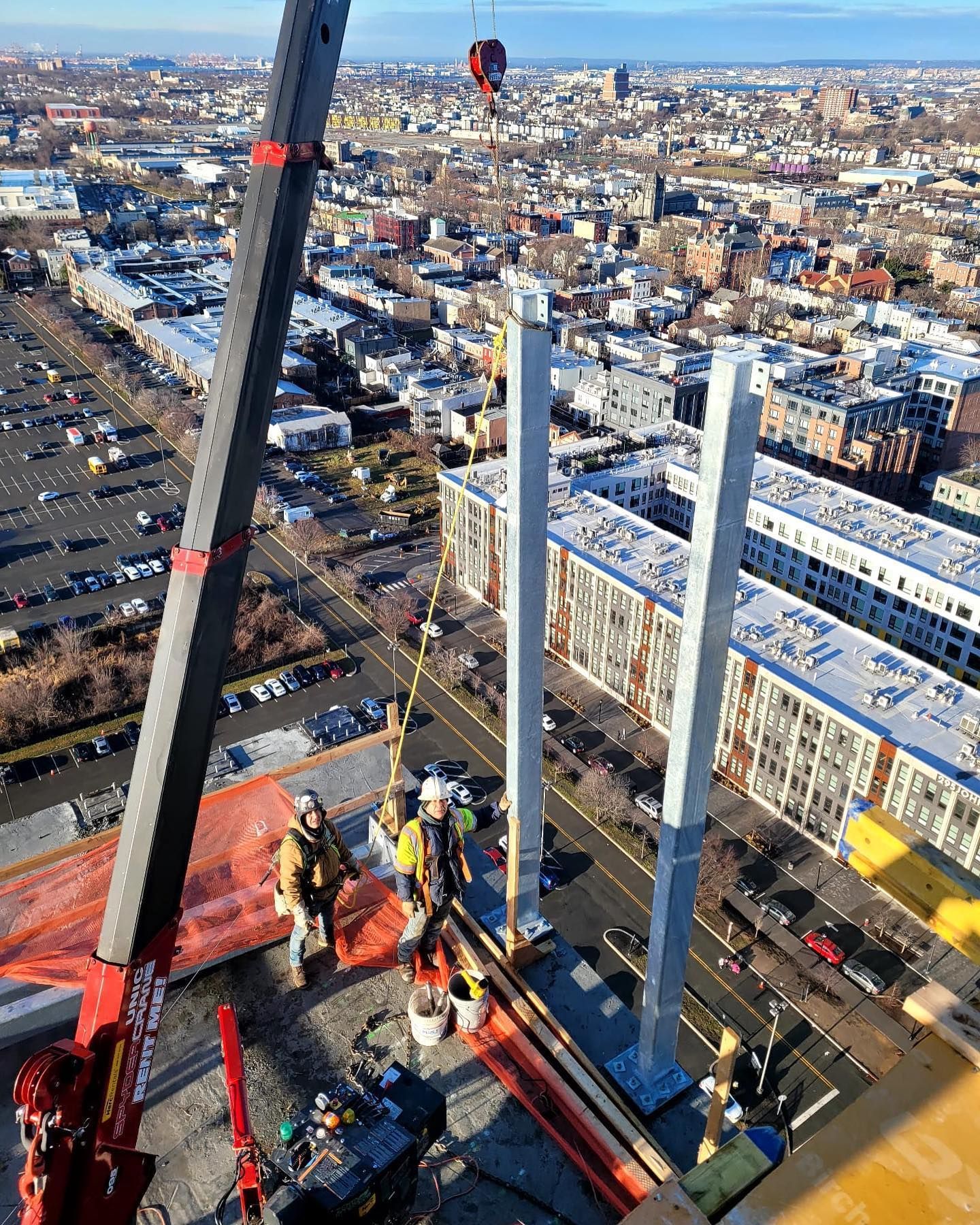 An aerial view of a construction site with a crane and workers.