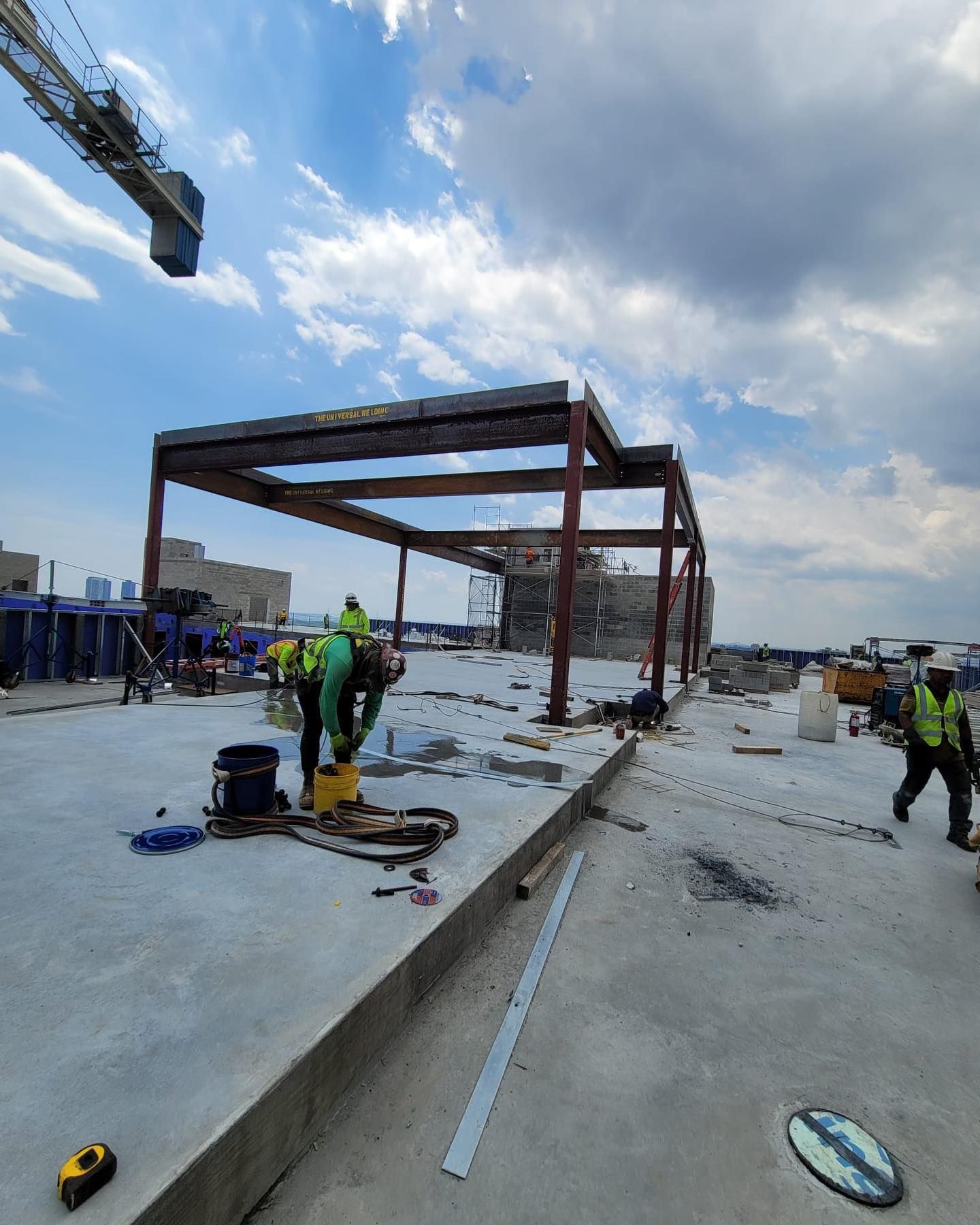 A group of construction workers are working on a building under construction.