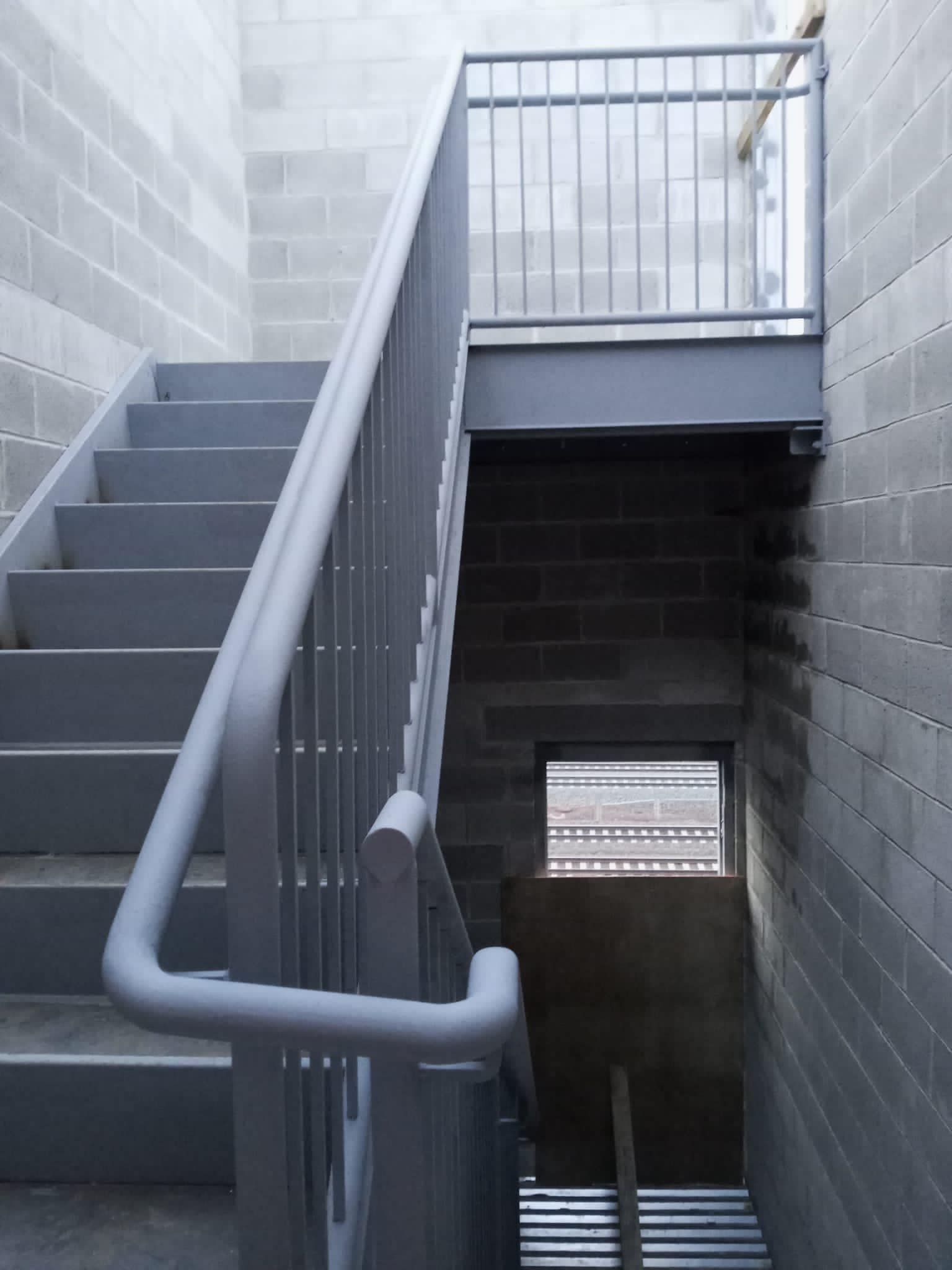 A set of stairs leading up to a brick wall