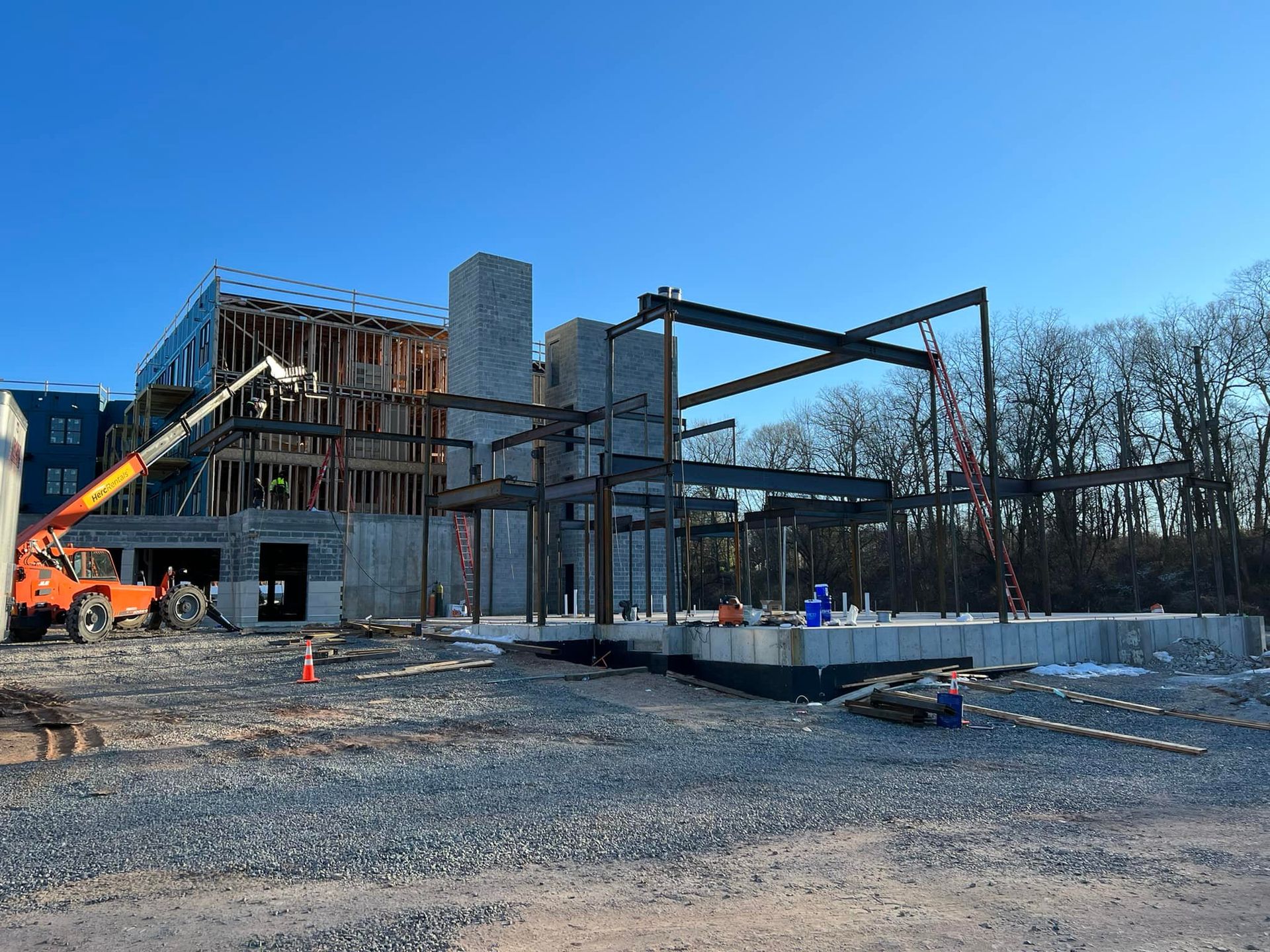 A large building under construction with a crane in the foreground