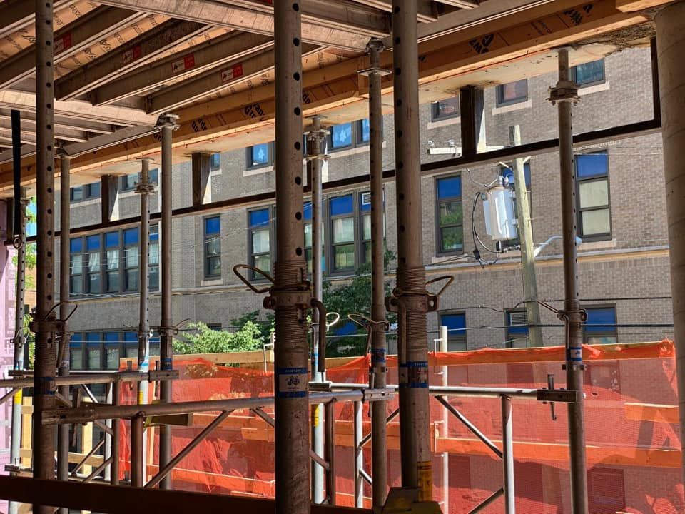 A construction site with scaffolding and a building in the background
