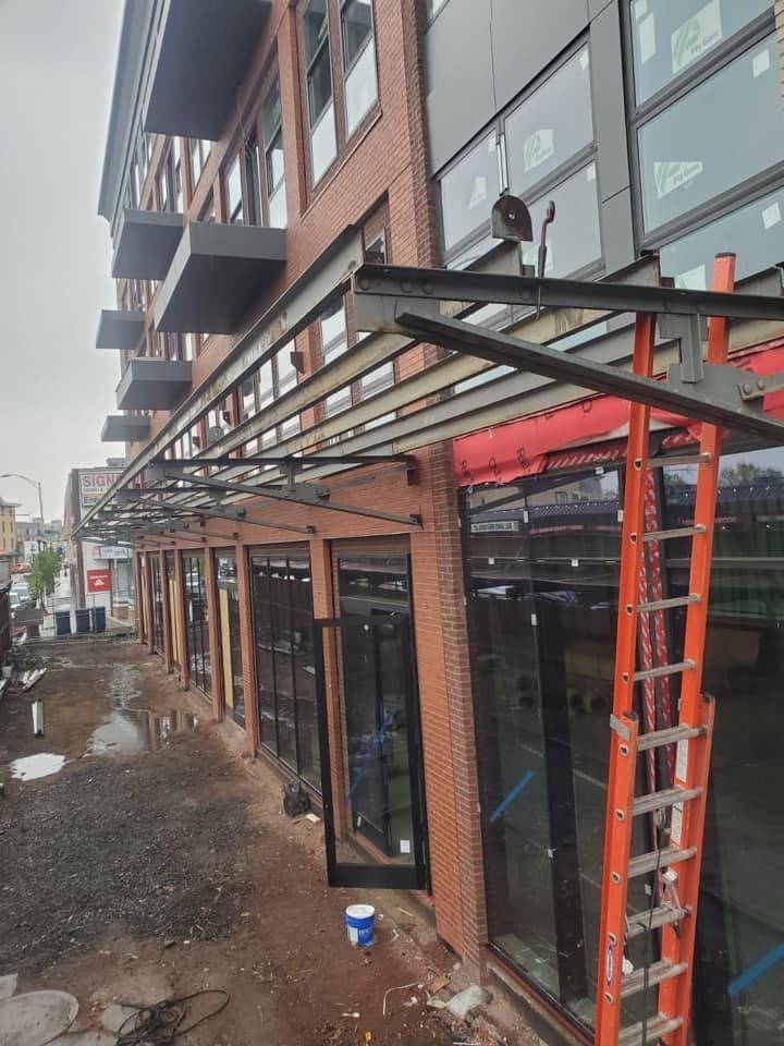 A building under construction with a ladder in front of it