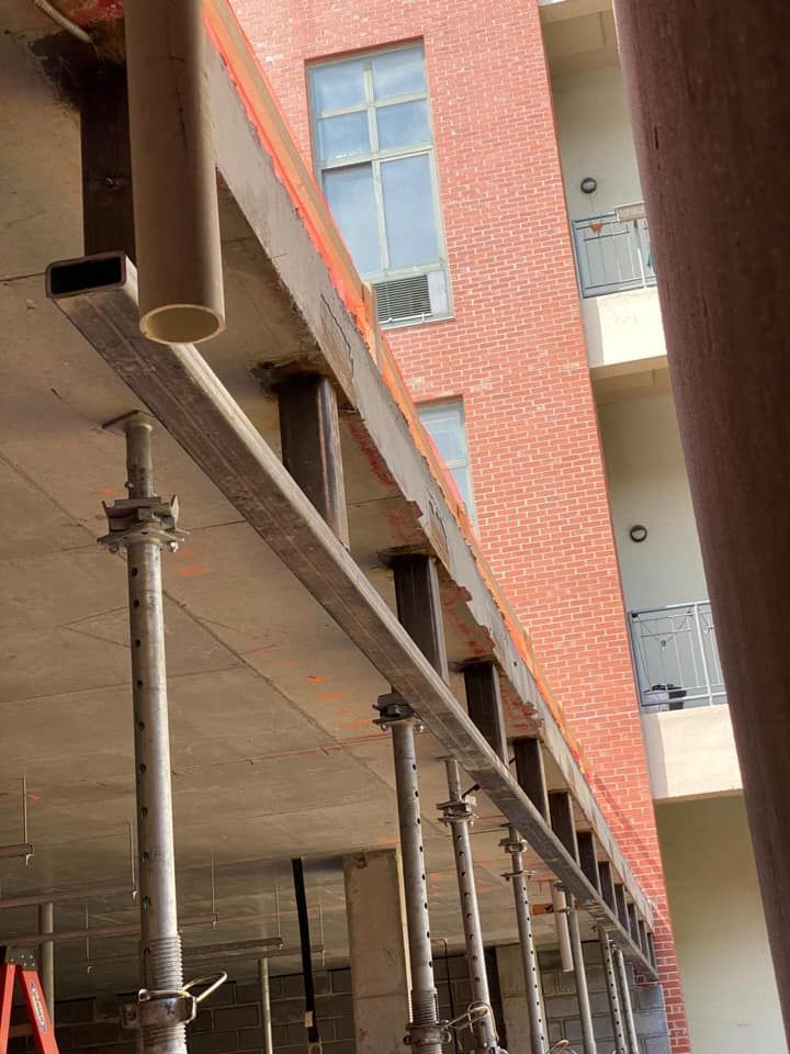 A building under construction with scaffolding in front of it