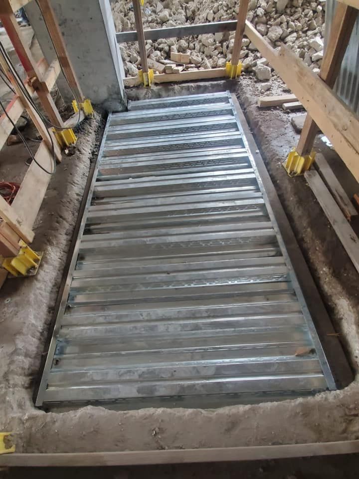 A metal staircase is being built in a building under construction.