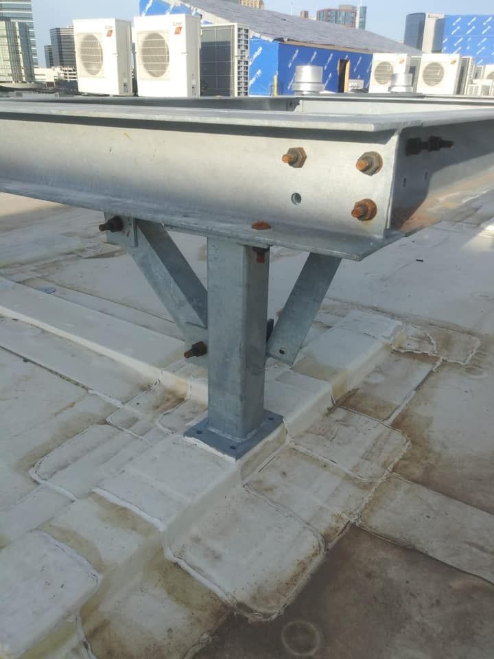 A metal structure is sitting on top of a concrete roof.