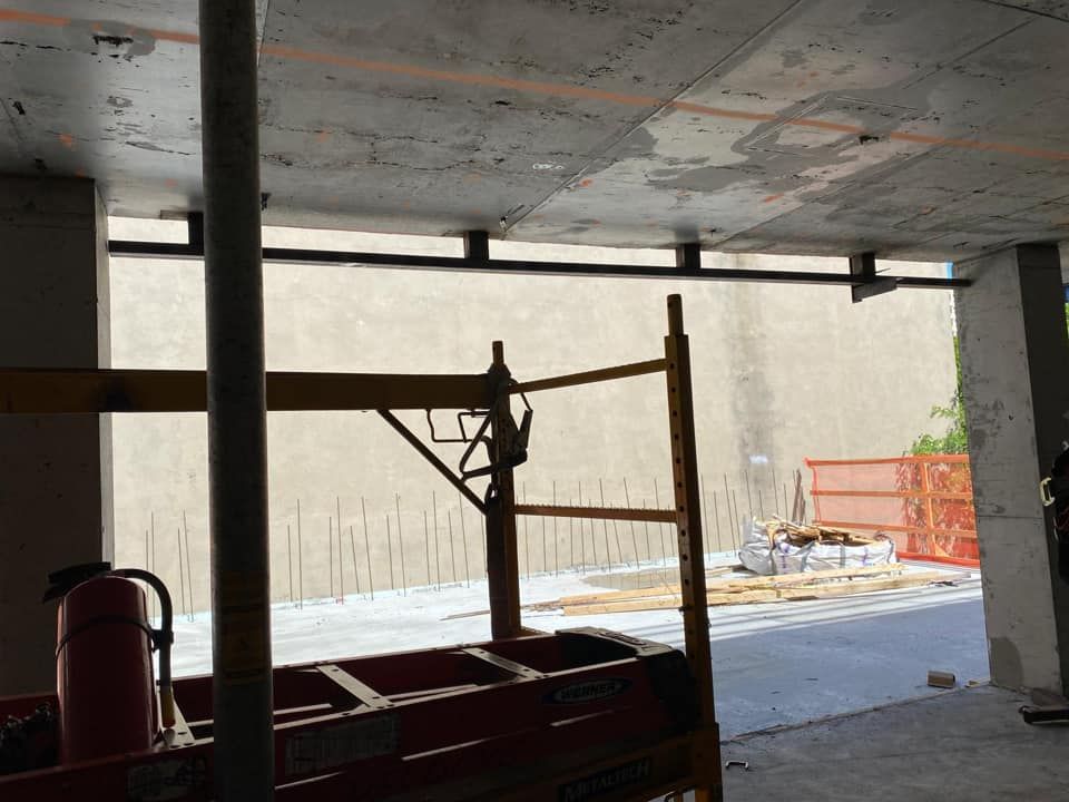 A fire extinguisher is sitting in a building under construction