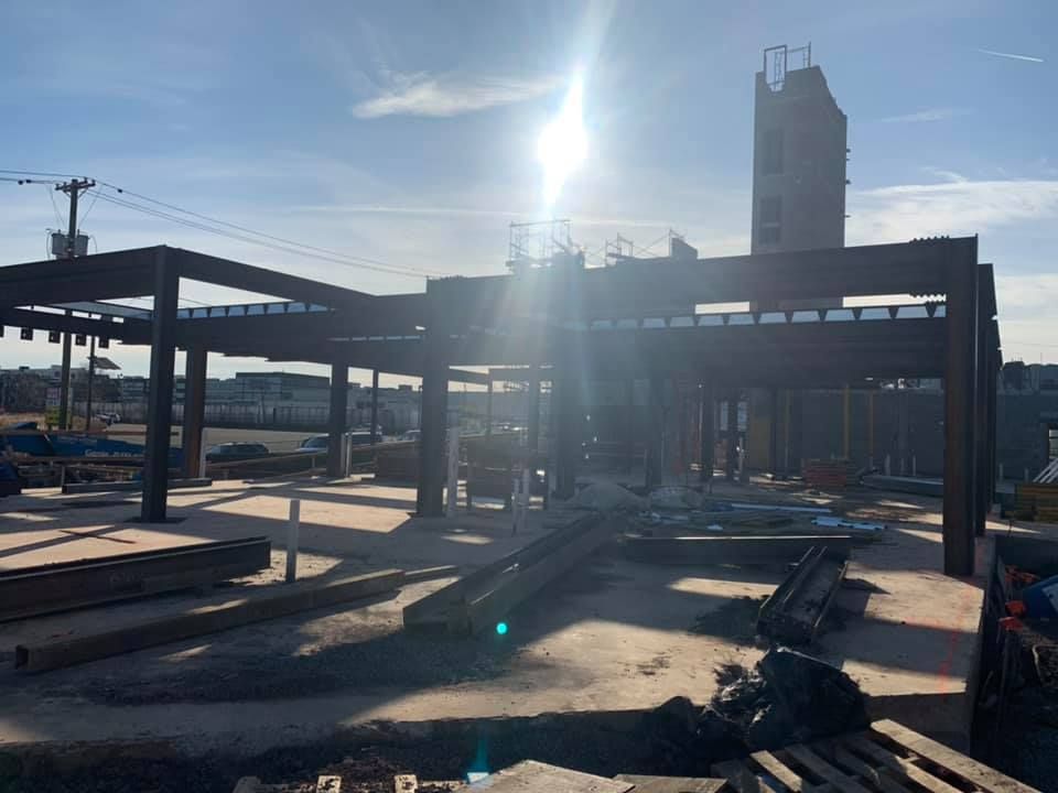 A building under construction with the sun shining through the roof.