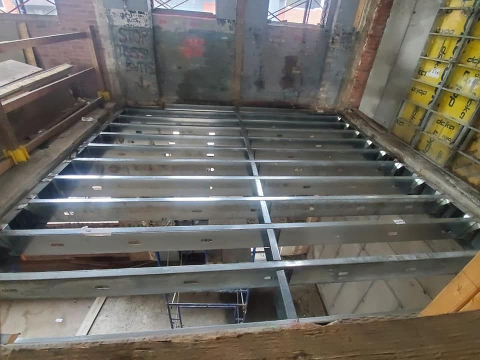 A metal floor is being built in a building.