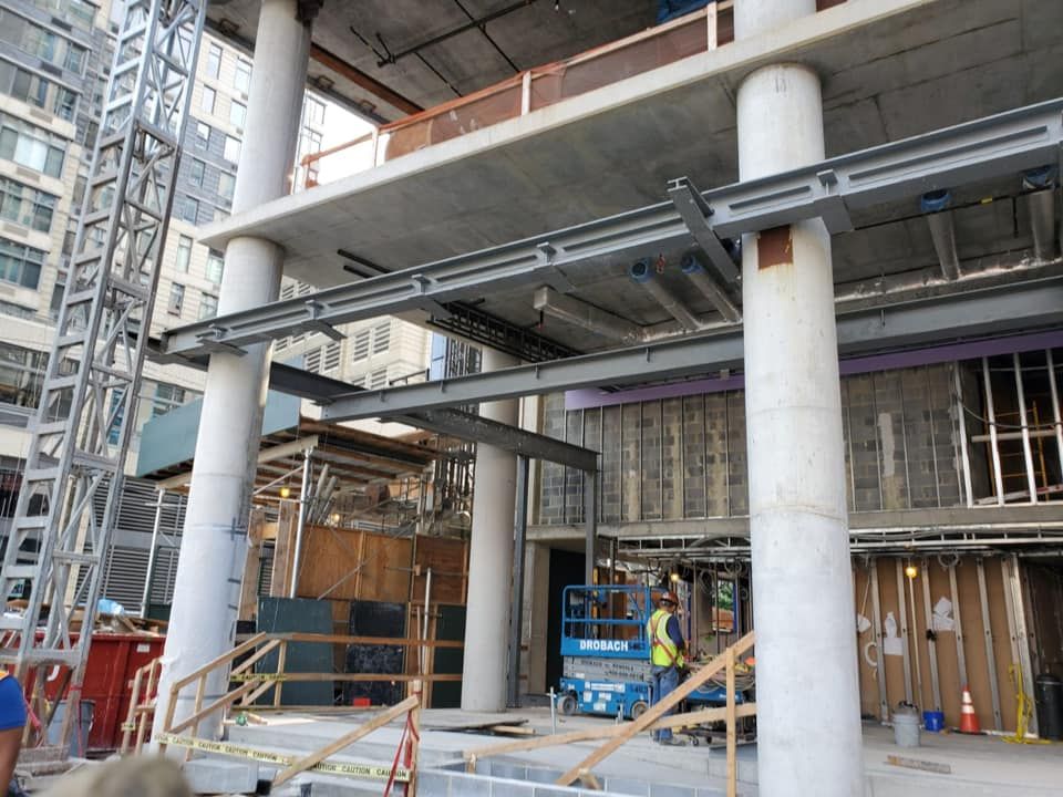 A large building under construction with a lot of columns and stairs.