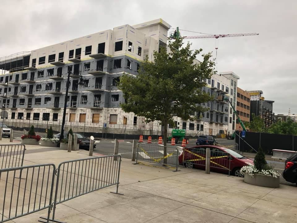 A large building is being built in the middle of a city.