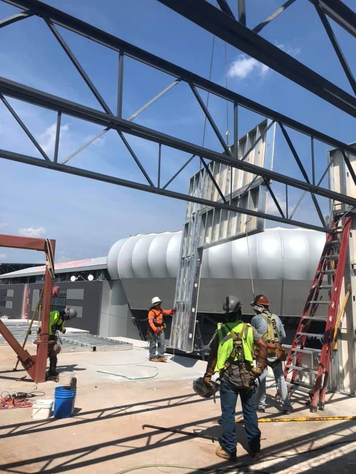 A group of construction workers are working on a building.